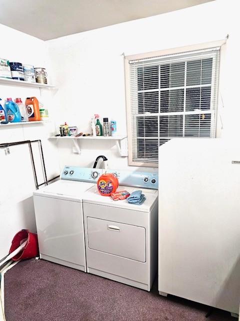 laundry area with washer and clothes dryer and carpet floors