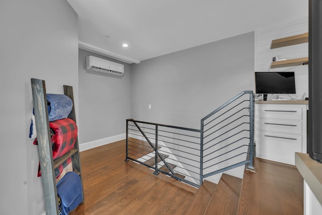 hall featuring dark hardwood / wood-style flooring and an AC wall unit