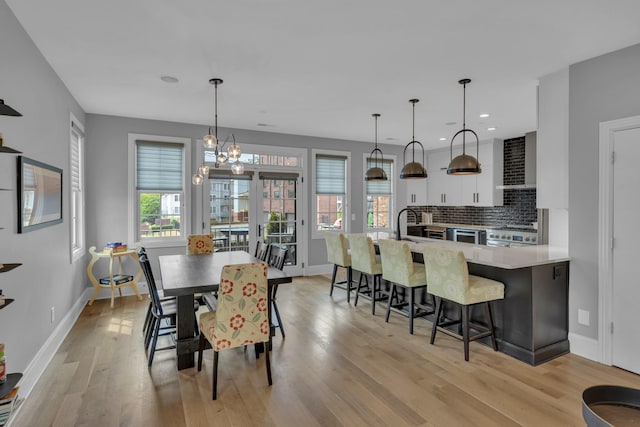 dining room featuring a chandelier and light hardwood / wood-style flooring