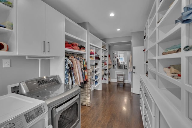 laundry room with cabinets, dark wood-type flooring, and washer and dryer