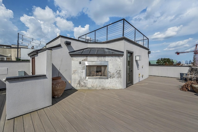 wooden terrace with exterior fireplace