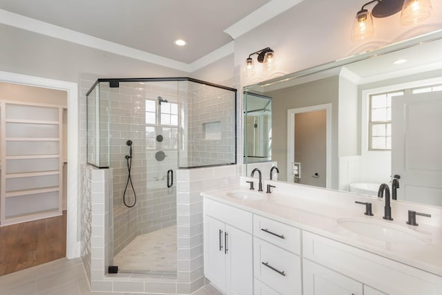 bathroom with tile patterned flooring, ornamental molding, vanity, and a shower with shower door