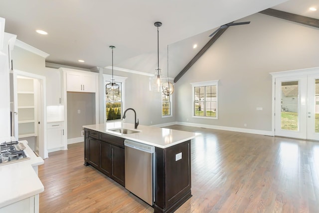 kitchen featuring a center island with sink, sink, hanging light fixtures, stainless steel dishwasher, and ceiling fan