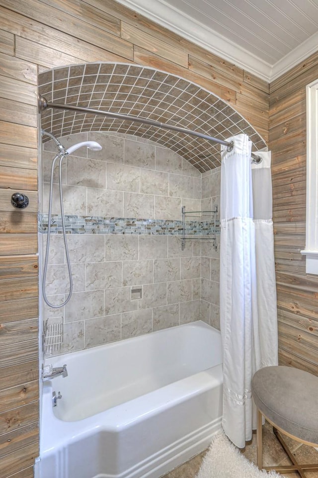 bathroom with tile patterned floors, wooden walls, and shower / tub combo