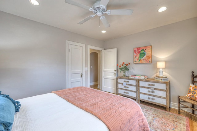 bedroom with ceiling fan and wood-type flooring