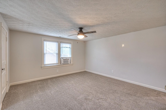 unfurnished room with ceiling fan, carpet, and a textured ceiling