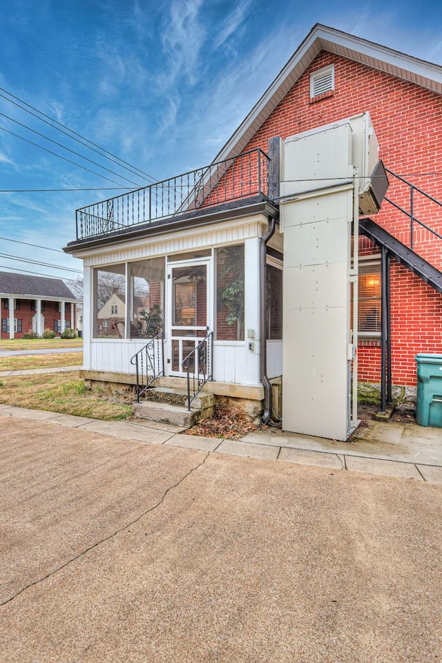 view of front of house with a sunroom