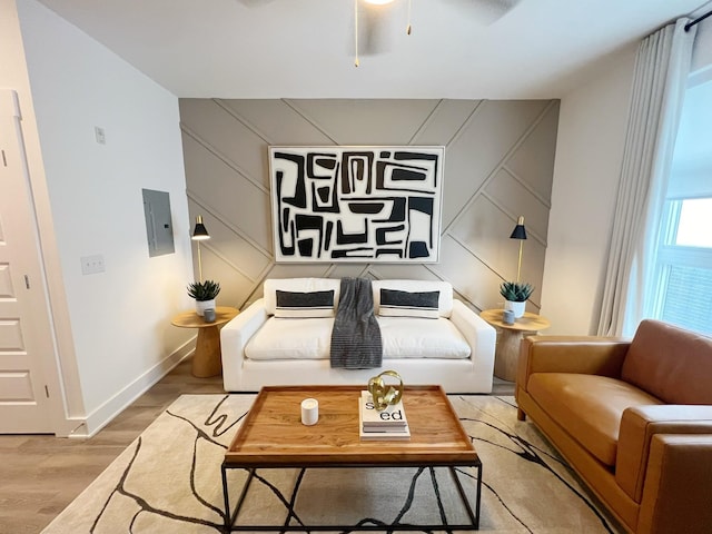 living room featuring ceiling fan and light hardwood / wood-style floors