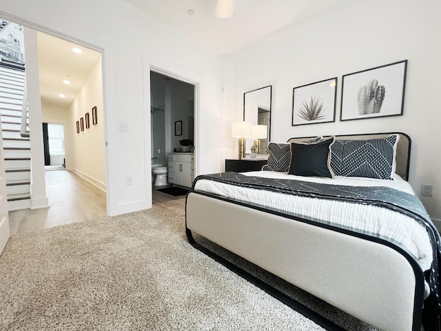 bedroom with carpet flooring, ensuite bath, and ceiling fan