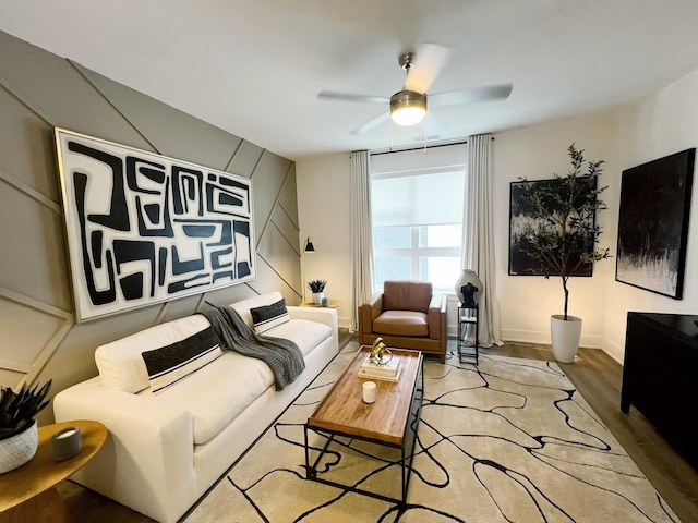 living room with light hardwood / wood-style flooring and ceiling fan