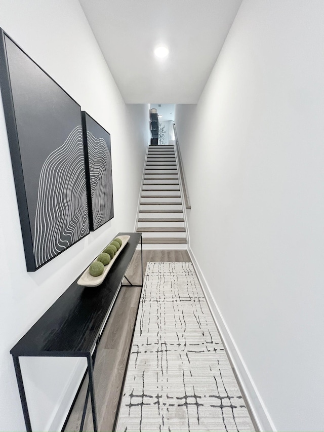 hallway with light hardwood / wood-style floors