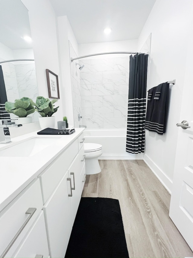 full bathroom with toilet, vanity, shower / bath combination with curtain, and hardwood / wood-style flooring