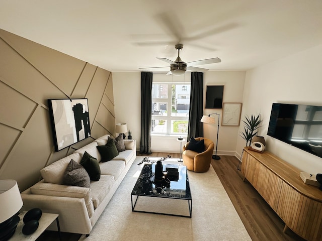 living room with wood-type flooring and ceiling fan