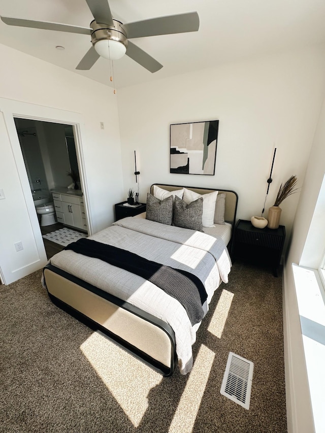 bedroom featuring carpet, ensuite bathroom, and ceiling fan