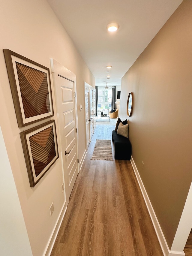 corridor with wood-type flooring