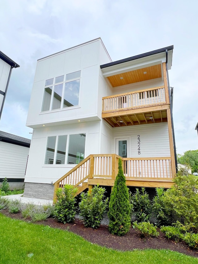 back of house featuring a balcony