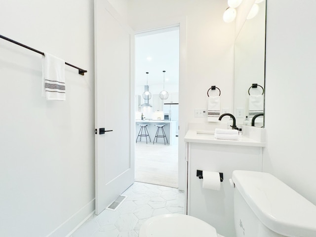 bathroom featuring vanity and toilet