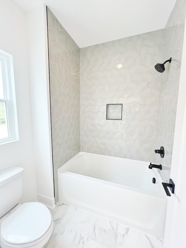 bathroom featuring toilet and washtub / shower combination