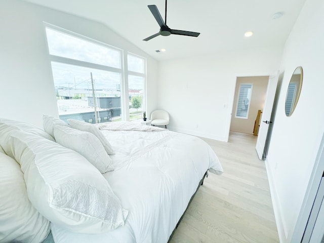 bedroom featuring ceiling fan, light hardwood / wood-style floors, and vaulted ceiling