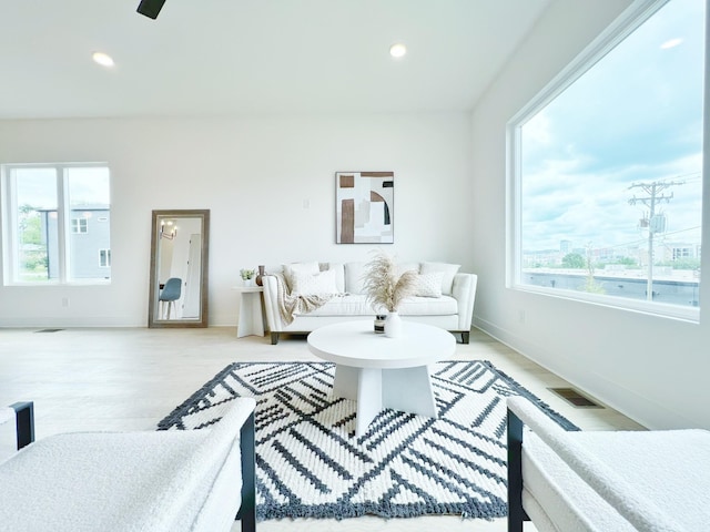 living room with light wood-type flooring and a wealth of natural light