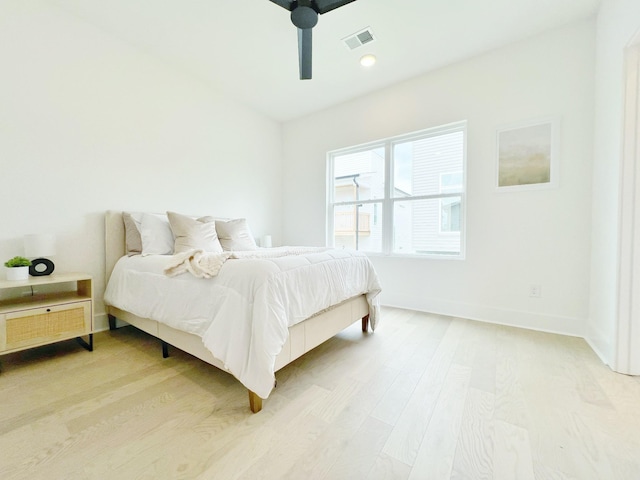 bedroom with light hardwood / wood-style floors and ceiling fan