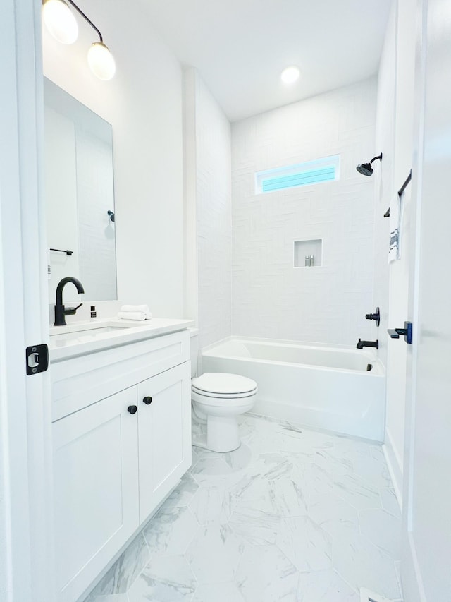 full bathroom featuring toilet, vanity, and tiled shower / bath