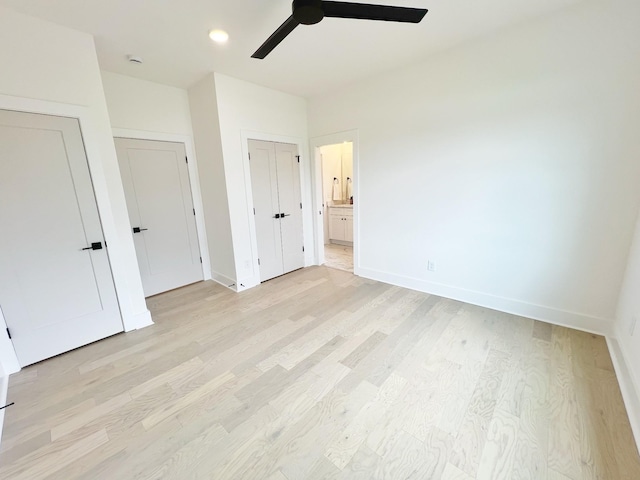 unfurnished bedroom with ceiling fan, light hardwood / wood-style floors, and ensuite bath