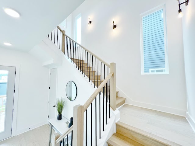 staircase with hardwood / wood-style flooring