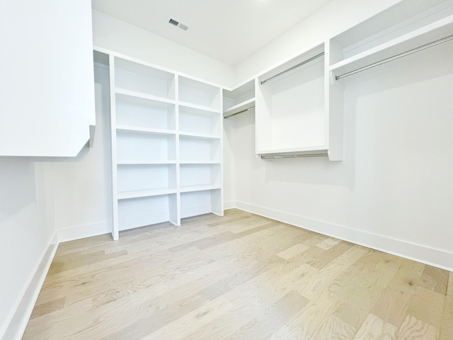 spacious closet featuring light wood-type flooring