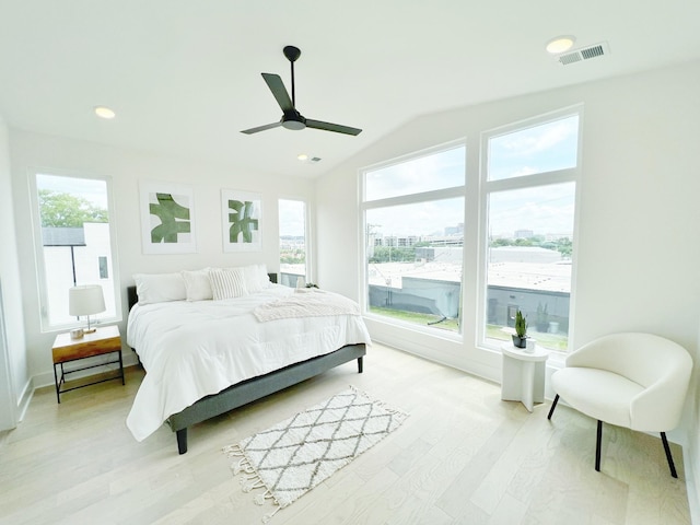 bedroom with light hardwood / wood-style flooring, ceiling fan, and lofted ceiling