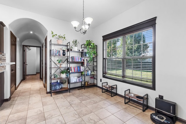 tiled dining area with a chandelier