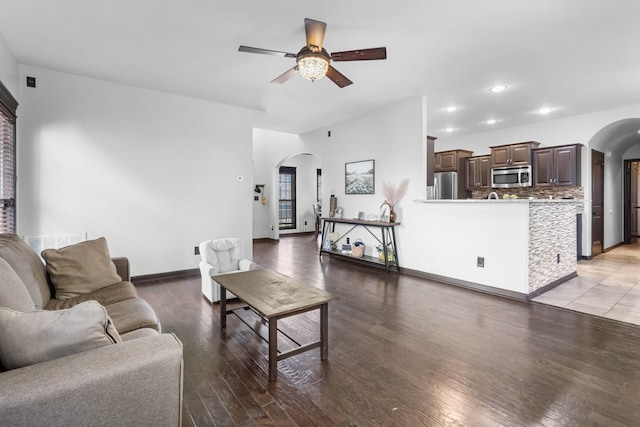 living room featuring ceiling fan and light hardwood / wood-style flooring