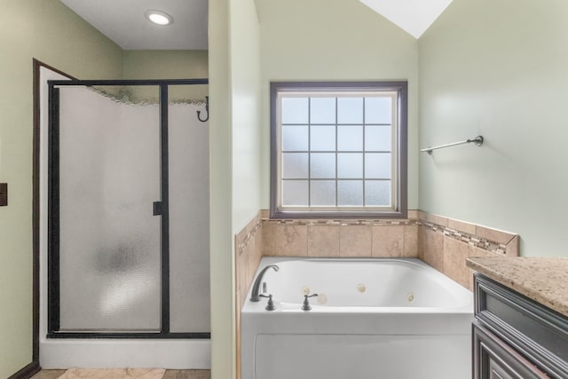 bathroom featuring vanity, lofted ceiling, and shower with separate bathtub