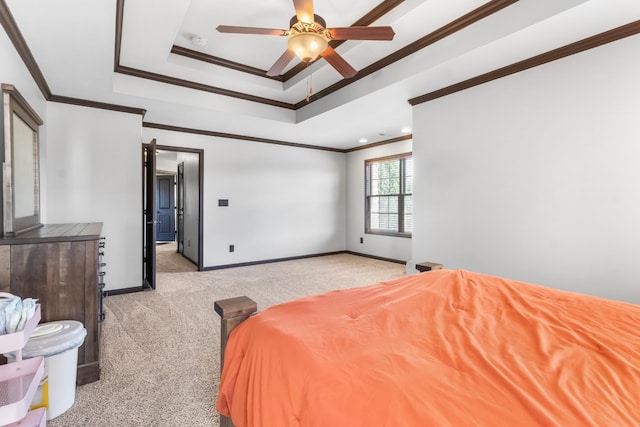 carpeted bedroom featuring ceiling fan, crown molding, and a tray ceiling