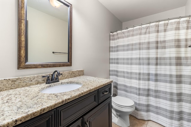 bathroom with tile patterned flooring, vanity, and toilet