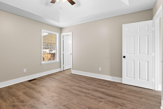 spare room with ceiling fan and wood-type flooring