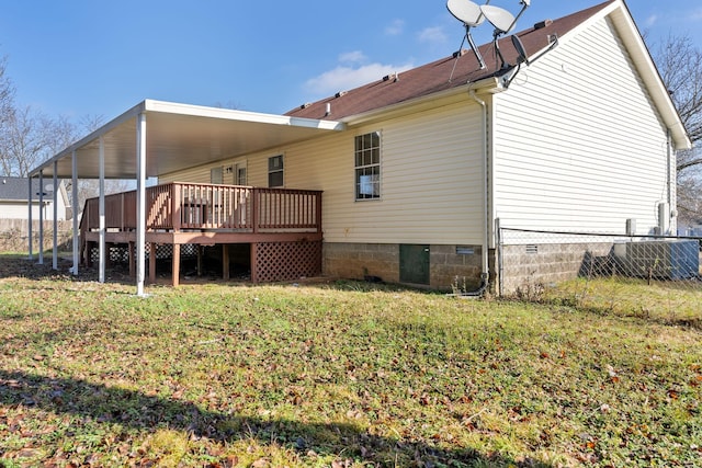 back of house featuring a yard and a wooden deck