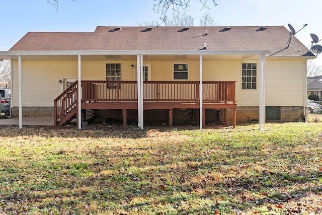 back of property featuring a deck and a yard