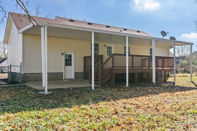 rear view of house with a deck and a patio area