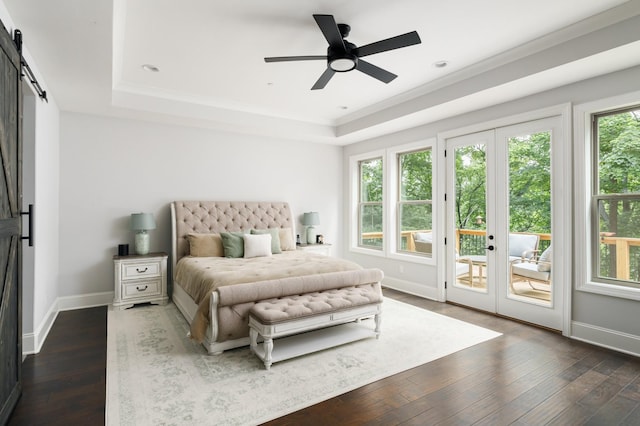 bedroom featuring access to exterior, ceiling fan, french doors, a raised ceiling, and a barn door