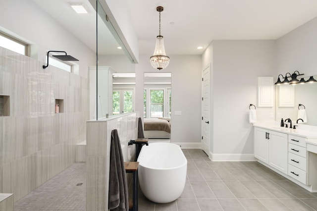 bathroom with tile patterned flooring, shower with separate bathtub, vanity, and an inviting chandelier