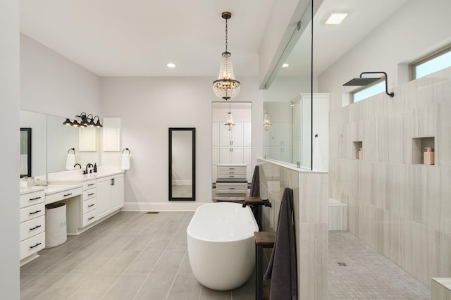 bathroom featuring tile patterned floors, vanity, plus walk in shower, and an inviting chandelier