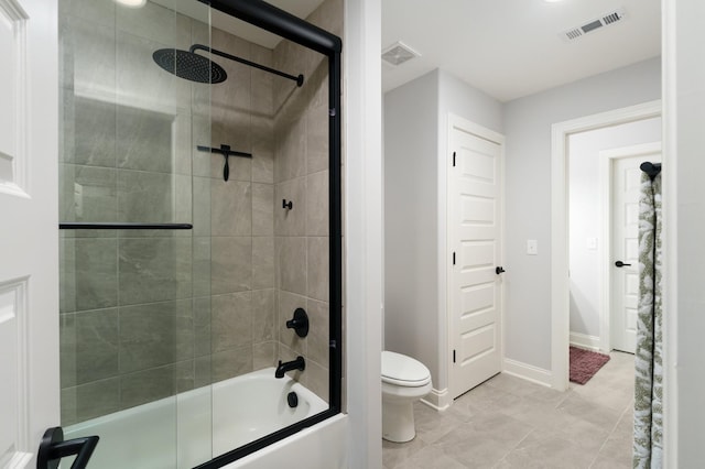 bathroom with bath / shower combo with glass door and toilet