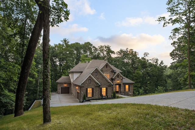 view of front of home featuring a lawn and a garage