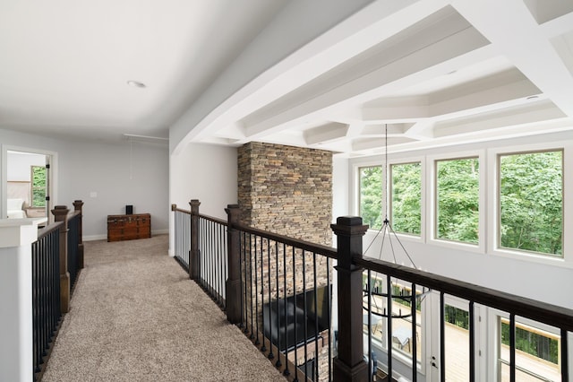 corridor with beam ceiling, light carpet, and coffered ceiling