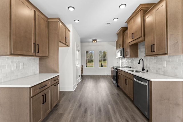 kitchen featuring tasteful backsplash, stainless steel appliances, dark hardwood / wood-style floors, and sink