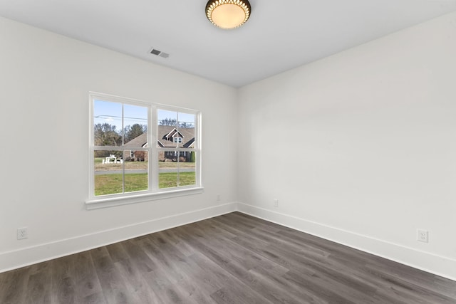 empty room featuring dark wood-type flooring