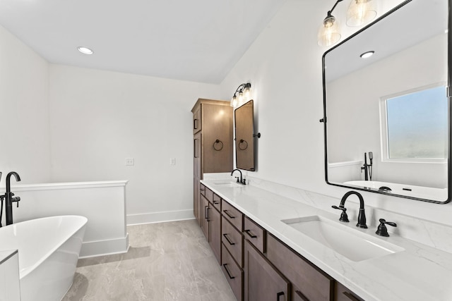 bathroom with a bath, vanity, and wood-type flooring