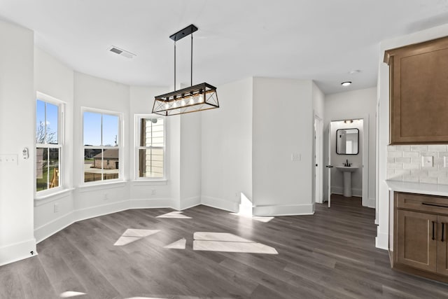 unfurnished dining area with dark hardwood / wood-style flooring