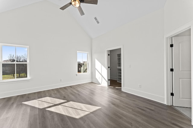 unfurnished living room with dark hardwood / wood-style floors, high vaulted ceiling, and ceiling fan